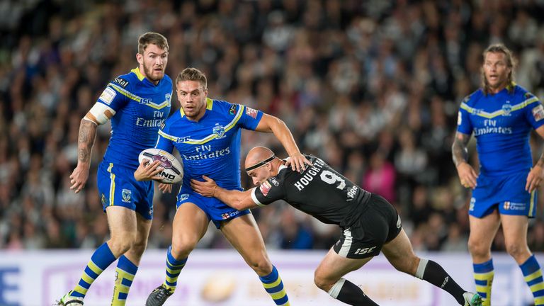 Matty Russell is tackled by Hull hooker Danny Houghton