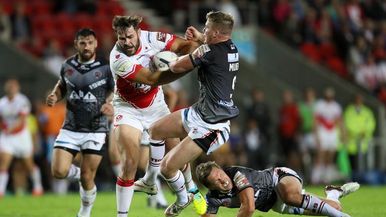 St Helens' Alex Walmsley is tackled by Castleford Tigers' Adam Milner,