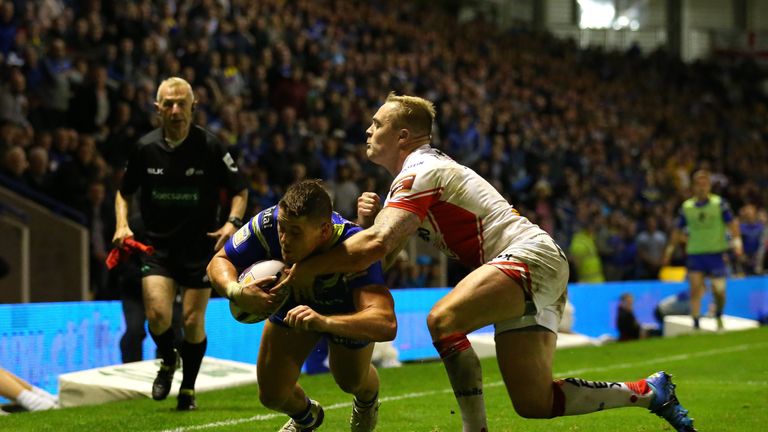 Tom Lineham of Warrington Wolves dives over the line to score a try