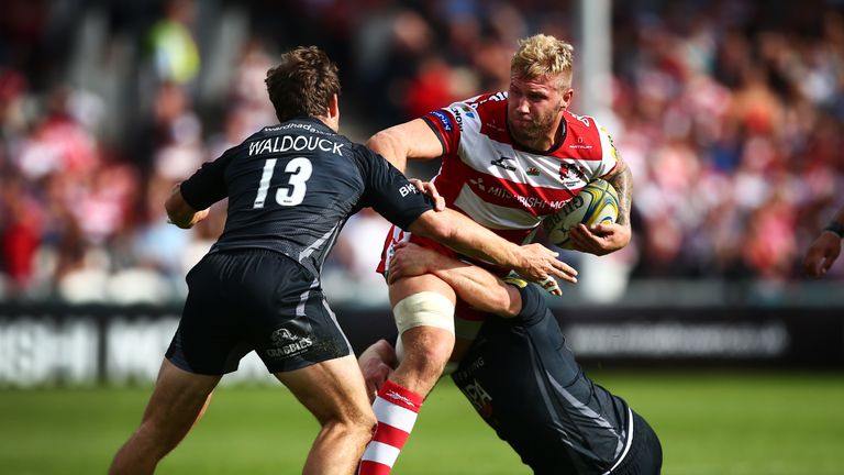 Ross Moriarty is tackled by Scott Lawson (right) and Dominic Waldouck of Newcastle