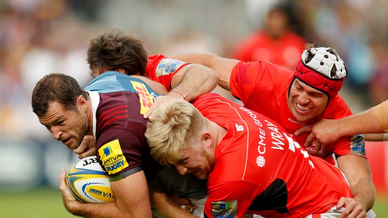 Tim Visser (left) is tackled by Saracens' Jackson Wray and Schalk Brits