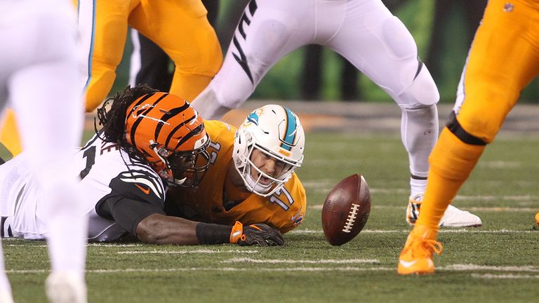 CINCINNATI, OH - SEPTEMBER 29:  Will Clarke #93 of the Cincinnati Bengals tackles Ryan Tannehill #17 of the Miami Dolphins and causes a fumble during the s