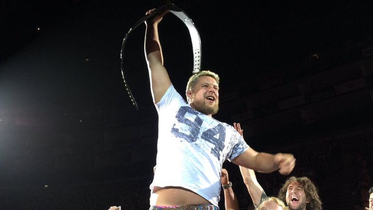 Richard Barrington holds the WWE title aloft