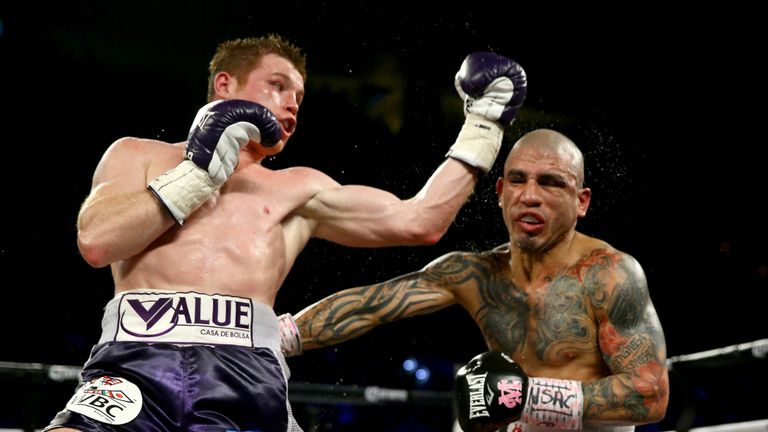 LAS VEGAS, NV - NOVEMBER 21:  (L-R)  Canelo Alvarez throws a left at Miguel Cotto during their middleweight fight at the Mandalay Bay Events Center on Nove