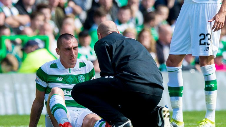 Scott Brown receives treatment before his substitution during Celtic's 5-1 win over Rangers