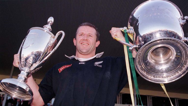 All Black captain Sean Fitzpatrick holds the Tri Nations trophy and Bledisloe Cup trophy back in 1998