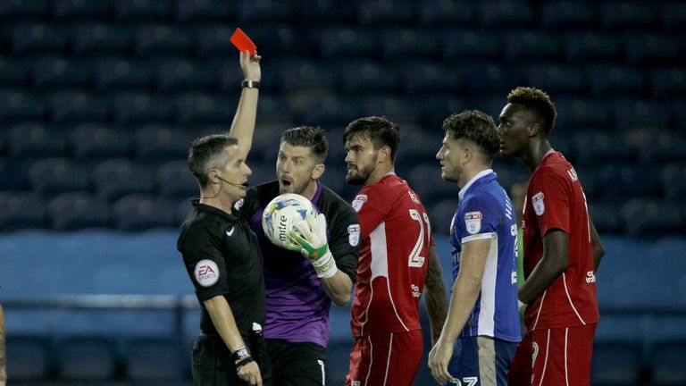 Sheffield Wednesday's Sam Hutchinson is shown the red card by referee Darren Bond as goalkeeper Keiren Westwood argues v Bristol City