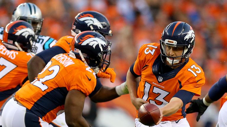 DENVER, CO - SEPTEMBER 08:  Quarterback Trevor Siemian #13 of the Denver Broncos hands the ball off to running back C.J. Anderson #22 against the Carolina 