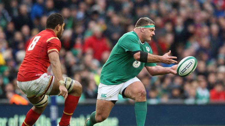 DUBLIN, IRELAND - FEBRUARY 07:  Nathan White of Ireland passes the ball as Taulupe Faletau of Wales closes in during the RBS Six Nations match between Irel