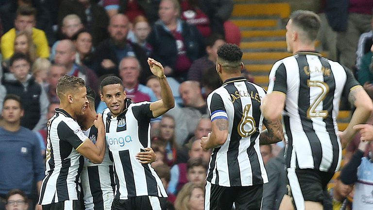 Newcastle United players celebrate after Aston Villa's Tommy Elphick (not pictured) scores an own goal 
