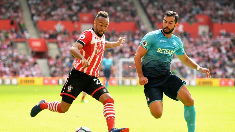 Nathan Redmond of Southampton (left) attmepts a shot while Swansea's Jordi Amat puts him under pressure 