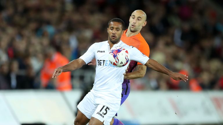Swansea City's Wayne Routledge and Manchester City's Pablo Zabaleta in EFL Cup action
