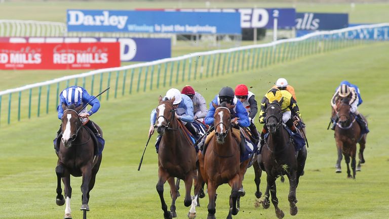 Talaayeb and Paul Mulrennan (black cap) come with a winning challenge down the centre to win the newmarketracourses.co.uk Maiden Fillies' Stakes.