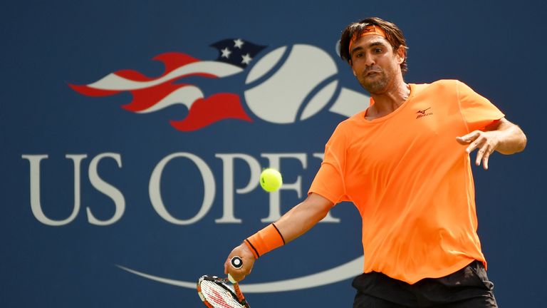 Marcos Baghdatis of Cyprus returns a shot to Ryan Harrison of the United States during the US Open