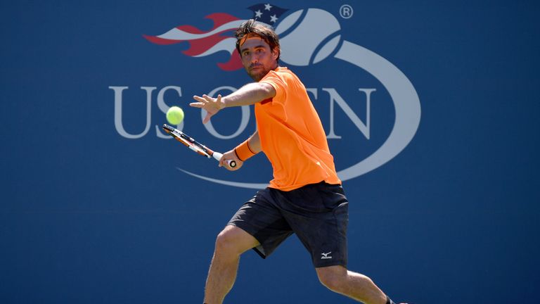 Marcos Baghdatis of Cyprus returns a shot to Gael Monfils of France during the US Open