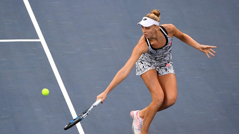 Naomi Broady of the United Kingdom returns a shot to Agnieszka Radwanska of Poland