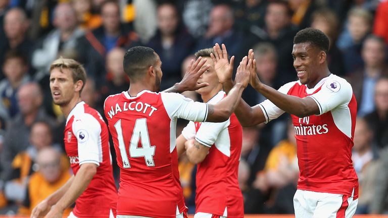 HULL, ENGLAND - SEPTEMBER 17: Alex Iwobi of Arsenal (R) celebrates creating his sides first goal with Theo Walcott of Arsenal  during the Premier League ma