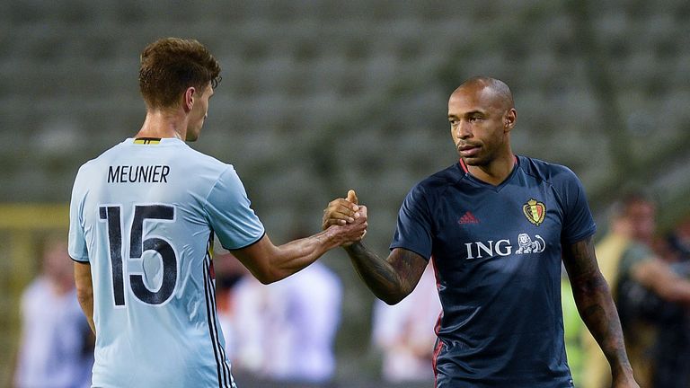 Thomas Meunier (L) shakes hands with Belgium's national team assistant coach Thierry Henry (R)
