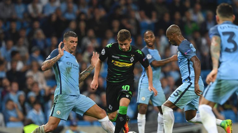 Moenchengladbach's Belgian midfielder Thorgan Hazard (C) tries to wriggle past Manchester City's Serbian defender Aleksandar Kolarov (L) and Manchester Cit