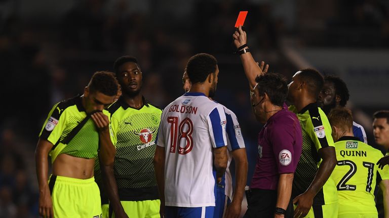  Tyler Blackett of Reading (2nd L) is given a straight red card by referee Lee Probert