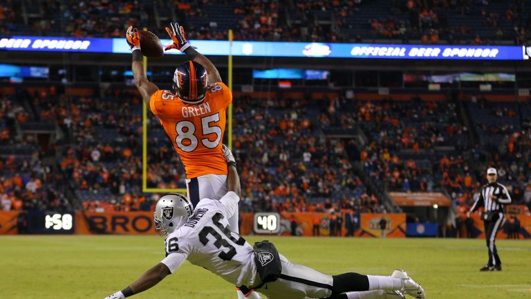 DENVER, CO - DECEMBER 28:  Tight end Virgil Green #85 of the Denver Broncos has a 1-yard fourth quarter touchdown reception under coverage by defensive bac