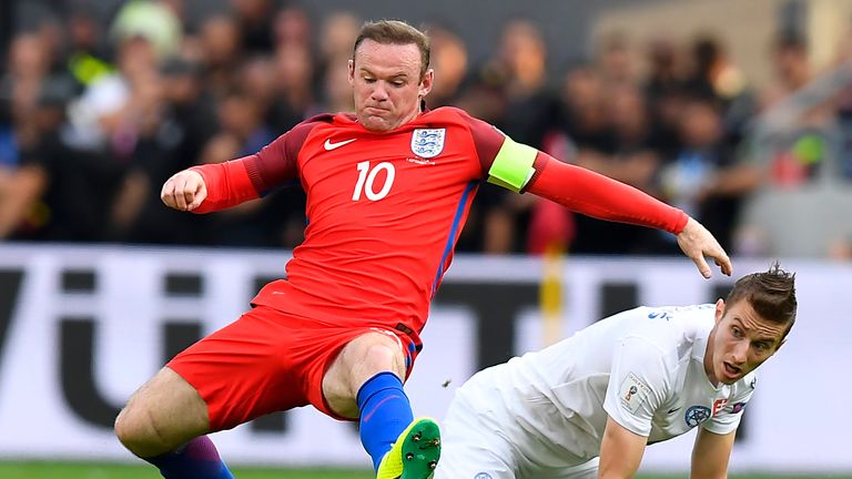 England's forward Wayne Rooney (L) vies with Slovakia's midfielder Jan Gregus