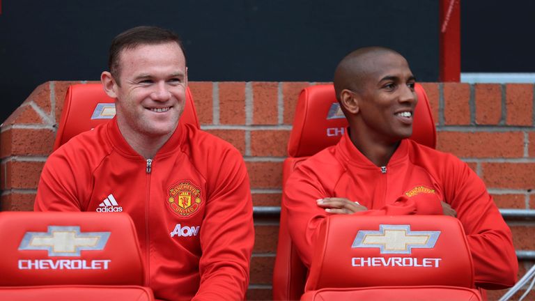 Manchester United's Wayne Rooney on the Old Trafford bench with Ashley Young