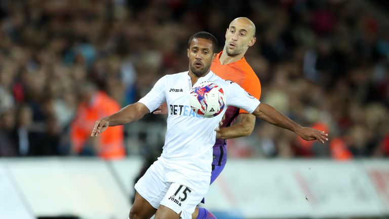 Swansea City's Wayne Routledge and Manchester City's Pablo Zabaleta during the EFL Cup, Third Round match at the Liberty Stadium, Swansea.