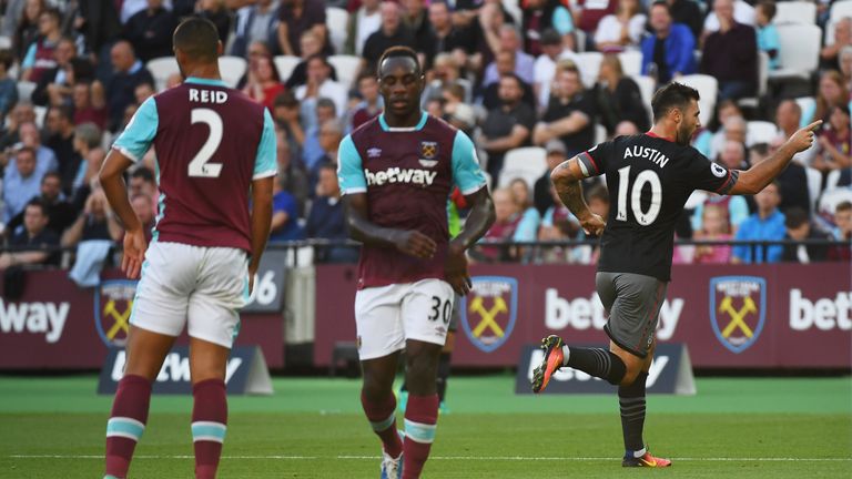 LONDON, ENGLAND - SEPTEMBER 25:  West Ham players look dejected as Charlie Austin of Southampton (10) celebrates as he scores their first goal during the P