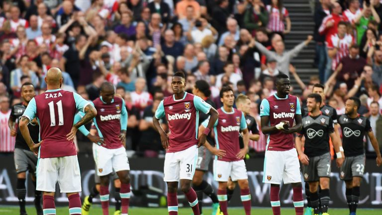 LONDON, ENGLAND - SEPTEMBER 25:  West Ham players look dejected as James Ward-Prowse of Southampton scores their third goal during the Premier League match