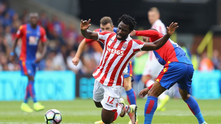LONDON, ENGLAND - SEPTEMBER 18: Wifried Bony of Stoke City (C) is fouled by Jason Puncheon of Crystal Palace (R) during the Premier League match between Cr