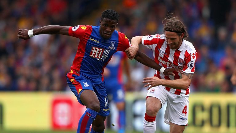 Wilfried Zaha of Crystal Palace (left) and Joe Allen of Stoke City battle for possession 