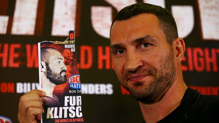 Wladimir Klitschko poses with an image of Tyson Fury after he failed to appear at a press conference ahead of the world title rematch