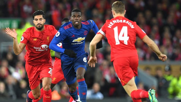 Paul Pogba attemps to break away Jordan Henderson and Emre Can at Anfield