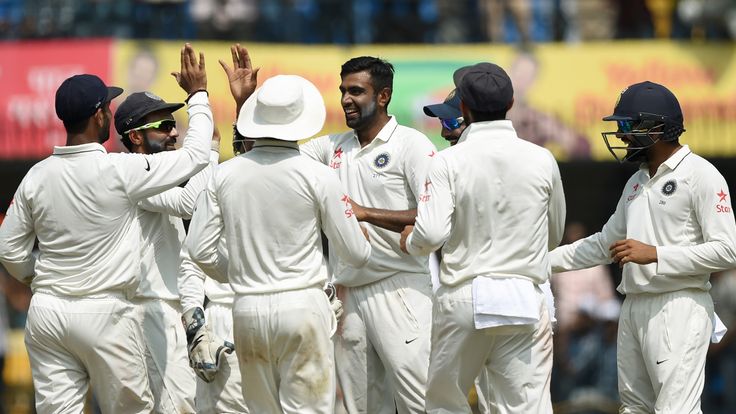 Indian bowler Ravichandran Ashwin (C) celebrates with teammates after the dismissal of New Zealand's batsman Martin Guptill