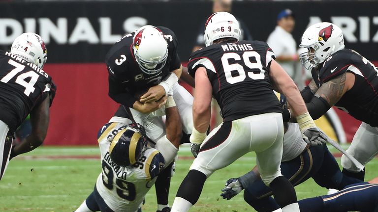 GLENDALE, AZ - OCTOBER 02:  Quarterback Carson Palmer #3 of the Arizona Cardinals is sacked by defensive tackle Aaron Donald #99 of the Los Angeles Rams du