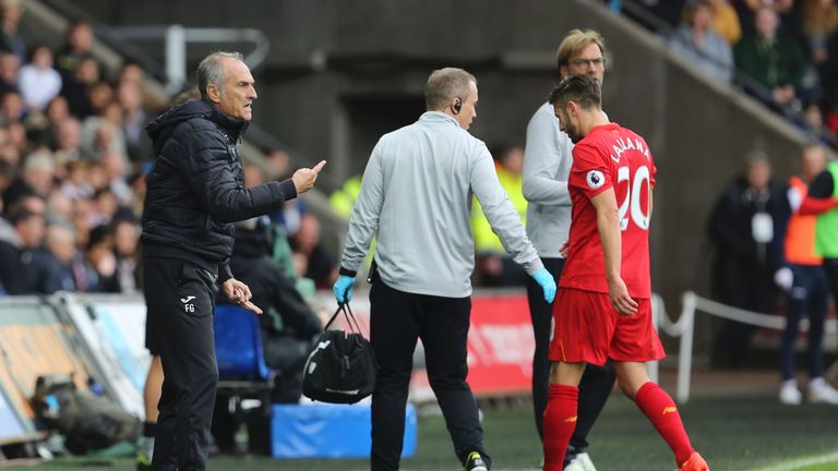 Liverpool and England midfielder Adam Lallana (R) left the pitch injured (R) against Swansea
