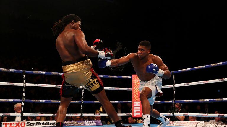 LONDON, ENGLAND - APRIL 09:  Anthony Joshua of England lands a punch on  Charles Martin of the United States during the IBF World Heavyweight title fight a