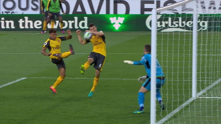 The ball hits Koscielny's hand before dropping over the line for Arsenal's late winner