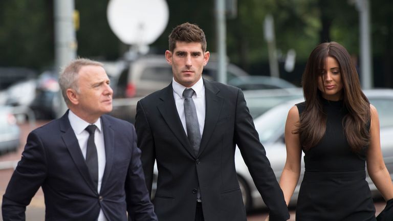 CARDIFF, WALES - OCTOBER 04: Chesterfield F.C football player Ched Evans (Centre) arrives at Cardiff Crown Court with partner Natasha Massey to stand trial
