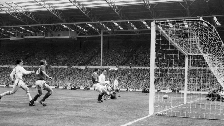 25th May 1963:  Leicester City goalkeeper Gordon Banks lies flat on the ground as he watches David Herd (left) score Manchester United's second goal, durin