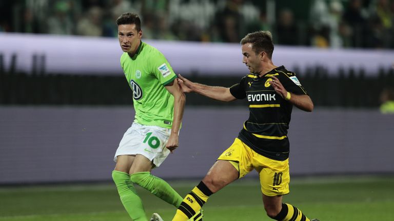 xxx (L) of Wolfsburg and xxx (R) of Dortmund compete for the ball during the during the Bundesliga match between 