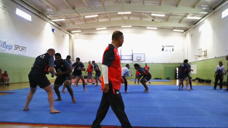 Eddie Jones, (C) the England head coach looks on as members of the England rugby tea takes part in a judo session