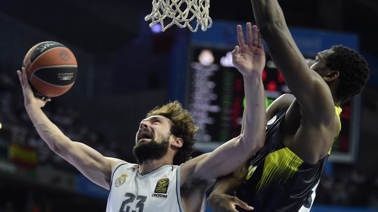 Real Madrid's guard Sergio Llull (L) vies with Fenerbahce Istambul's US center Ekpe Udoh during the Euroleague Game 3 playoff match Real madrid vs Fenerbah