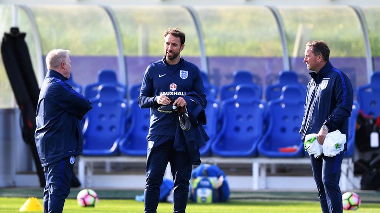 Interim England manager Gareth Southgate speaks with his coaching team