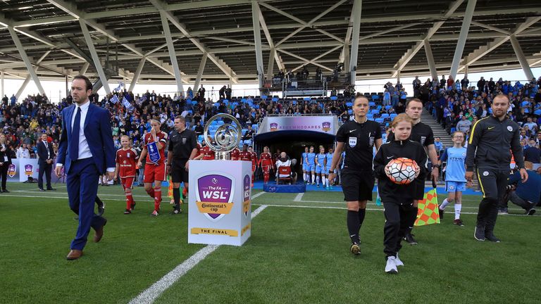 Nick Cushing (R) and manager of Birmingham City Ladies David Parker (L) lead their teams out
