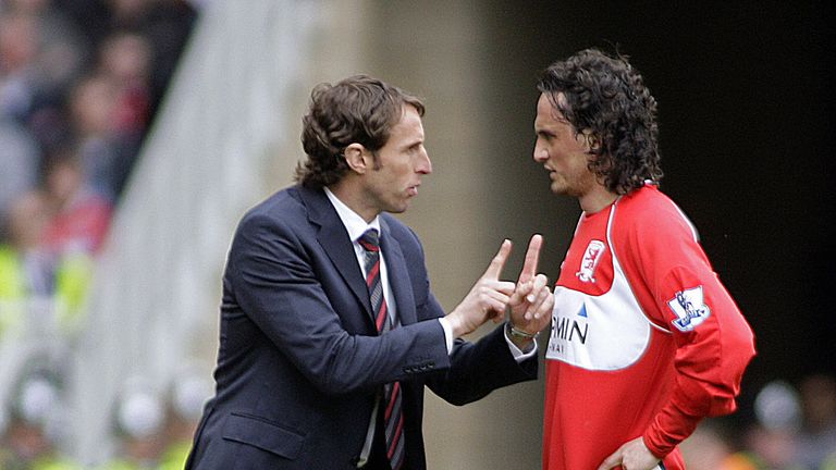 Middlesbrough's English manager Gareth Southgate (L) instructs his Turkish player Tuncay Sanli during the English Premier League football match between Mid