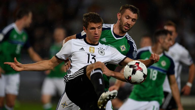 Germany midfielder Thomas Muller and Northern Ireland's Gareth McAuley vie for the ball during the WC 2018 football qualification match