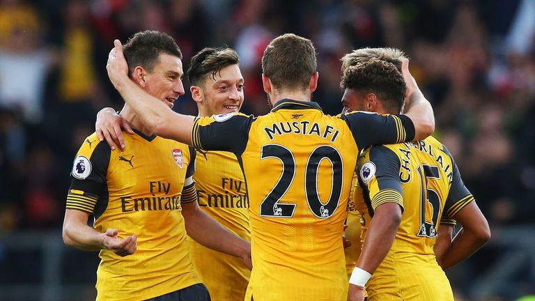 BURNLEY, ENGLAND - OCTOBER 02:  Laurent Koscielny of Arsenal (L) celebrates scoring his sides first goal with his team mates during the Premier League matc