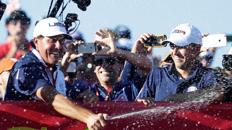 Phil Mickelson and Jordan Spieth of the United States celebrate with champagne after winning the Ryder Cup